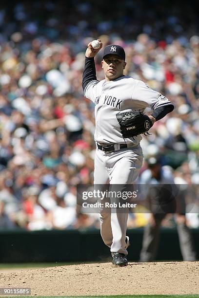 Alfredo Aceves of the New York Yankees throws over to first base during the game against the Seattle Mariners at Safeco Field on August 16, 2009 in...