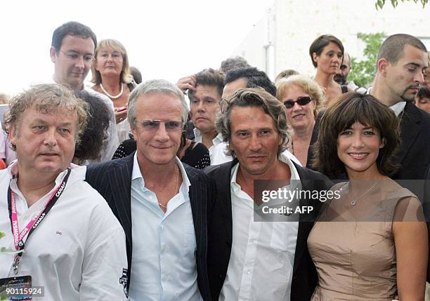 French speaking Cinema festival president Dominique Besnehard poses flanked by French actors Christophe Lambert and Sophie Marceau, and French...