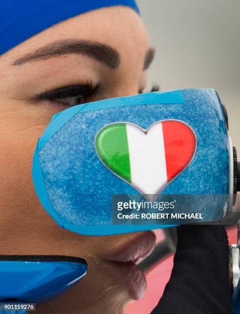 Dorothea Wierer of Italy adjusts her sight at the shooting range during the warm up prior to the women's 7,5 km sprint event of the IBU Biathlon...