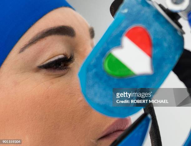 Dorothea Wierer of Italy adjusts her sight at the shooting range during the warm up prior to the women's 7,5 km sprint event of the IBU Biathlon...