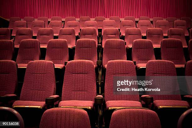 empty chairs in movie theater. - seat stock pictures, royalty-free photos & images