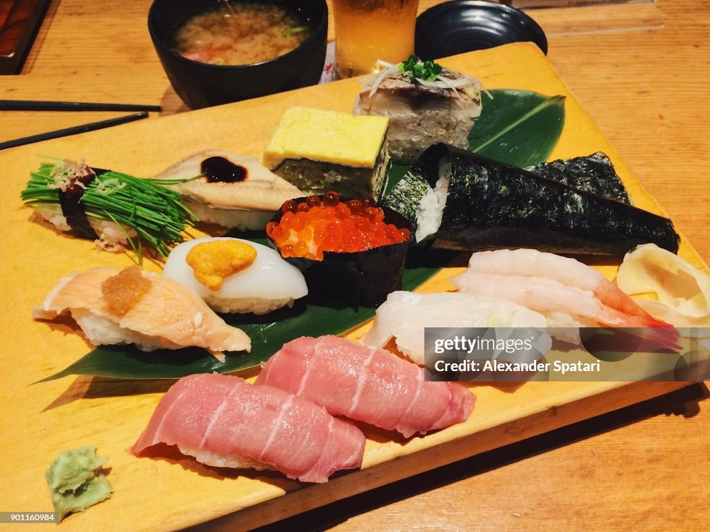 Close up of sushi nigiri set served on a wooden board