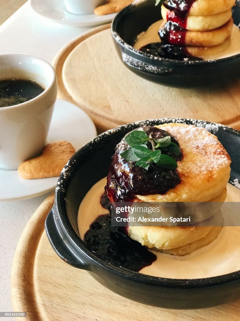Cottage cheese pancakes with jam and sour cream close up