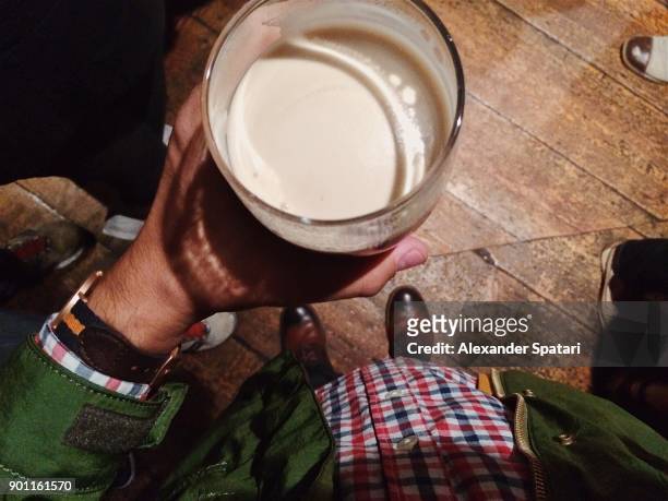 drinking beer in a pub from personal perspective - irish pub fotografías e imágenes de stock