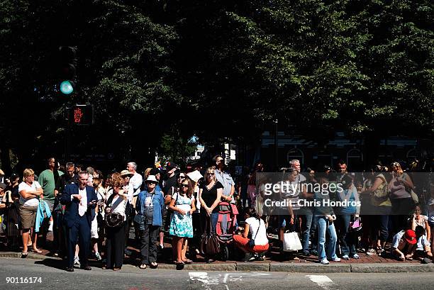 People wait for the motorcade carrying the body of U.S. Sen. Ted Kennedy across from Faneuil Hall August 27, 2009 in Boston, Massachusetts. Senator...
