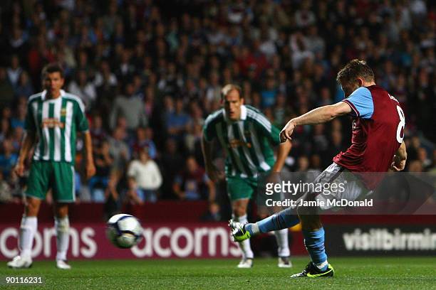 James Milner of Aston Villa scores the opening goal from the penalty spot during the UEFA Europa League Play off second leg match between Aston Villa...