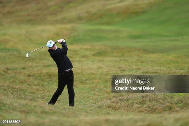 Hickman of Corpus Christi College Camridge plays his second shot on the sixth hole in his match against Roger Kelly of Corpus Christi College...