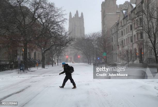 Woman walks through the campus of Yale University on January 4, 2018 in New Haven, Conneticut. The "bomb cyclone" was expected to dump heavy snows in...