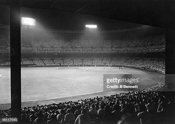 General view of a Cleveland Indians night game at Municipal Stadium in Cleveland, Ohio, circa 1940's.