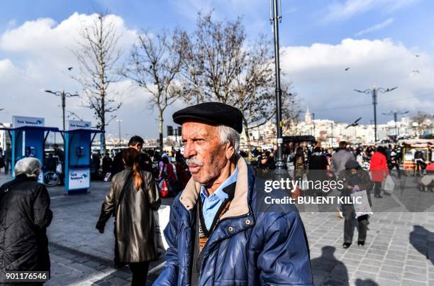 Man walks in Eminonu Square on the European side of Istanbul on January 4, 2018. / AFP PHOTO / BULENT KILIC