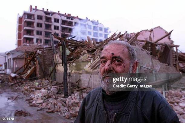An injured Serb man in front of his destroyed house in the town of Aleksinac, some 200 kilometers south of Belgrade, Yugoslavia, early Tuesday, April...