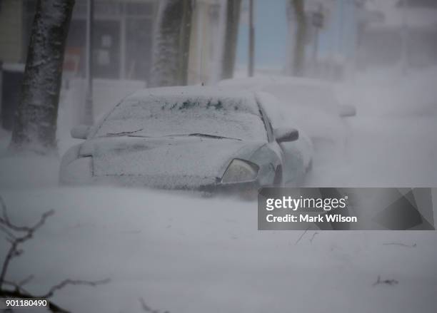 Cars are stuck in a snow drift during a storm, on January 4, 2018 in Ocean City, Maryland. A winter storm is traveling up the east coast of the...