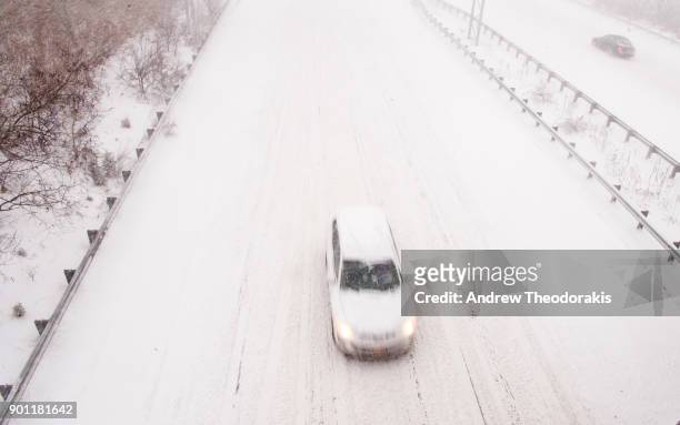 Commuters drive on the Sunrise Highway as a blizzard hits the Northeastern part of the United States on January 4, 2018 in Medford, New York.