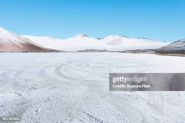 scenic view of frozen lake against sky during winter - frozen ground stock pictures, royalty-free photos & images