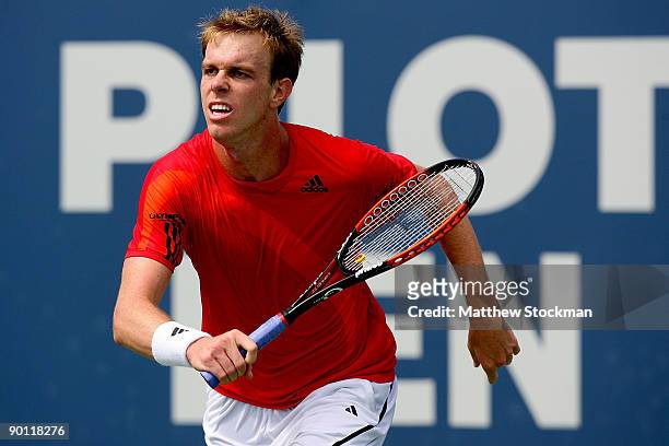 Sam Querrey chases down a ball while playing Nikolay Davydenko of Russia during the Pilot Pen Tennis tournament at the Connecticut Tennis Center at...