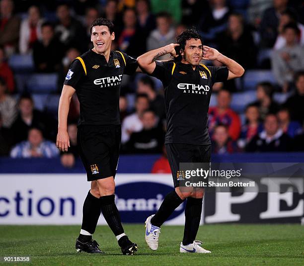 Carlos Tevez of Manchester City is congratulated by team-mate Gareth Barry after scoring during the Carling Cup second round match between Crystal...