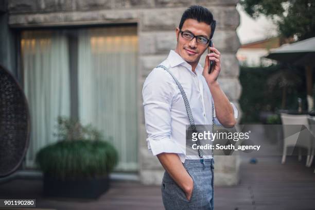 businessman using smart phone - wealthy asian man stock pictures, royalty-free photos & images