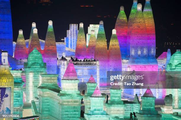 Tourists visit illuminated ice sculptures at Ice and Snow World park on January 4, 2018 in Harbin, China. The Ice and Snow World Park will host the...