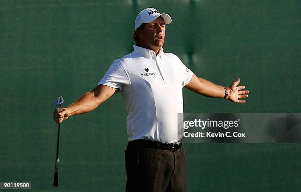 Phil Mickelson reacts after nearly chipping in for birdie on the 18th green during round one at The Barclays on August 27, 2009 at Liberty National...