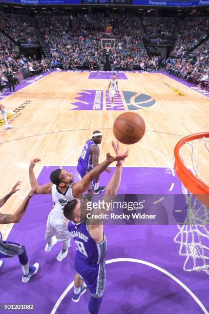 Bogdan Bogdanovic of the Sacramento Kings rebounds against Brandan Wright of the Memphis Grizzlies on December 31, 2017 at Golden 1 Center in...