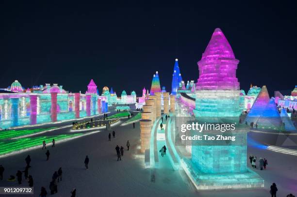 Tourists visit illuminated ice sculptures at Ice and Snow World park on January 4 2018 in Harbin, China. The Ice and Snow World Park will host the...