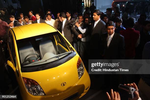 Crowd of visitors look at the newly launched Tata Nano car at the ninth Auto Expo on January 10, 2008 in New Delhi, India.