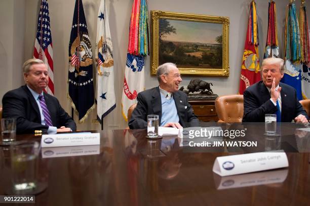 President Donald Trump jokes with US Senator Chuck Grassley , R-Iowa,that he likes Sen. Lindsey Graham R-SC during a meeting with Republican members...