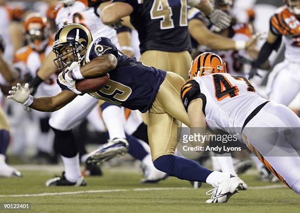 Wide receiver Ronald Curry of the St. Louis Rams is tackled by Corey Lynch of the Cincinnati Bengals during the preseason game at Paul Brown Stadium...