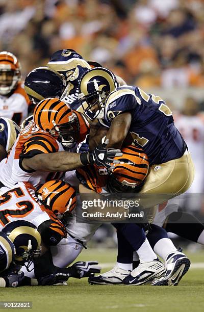 Running back Kenneth Darby of the St. Louis Rams runs into a pile of Cincinnati Bengals defenders during the preseason game at Paul Brown Stadium on...