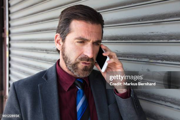 businessman talking on the phone - dark haired man gray shirt with wine stock pictures, royalty-free photos & images