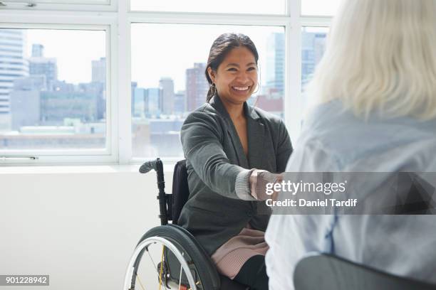 businesswoman with disability - happy asian woman bright office stock-fotos und bilder