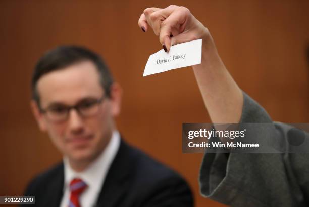 Slip of paper with the name of Virginia House of Delegates candidate David Yancey is shown during a meeting of the Virginia State Board of Elections...