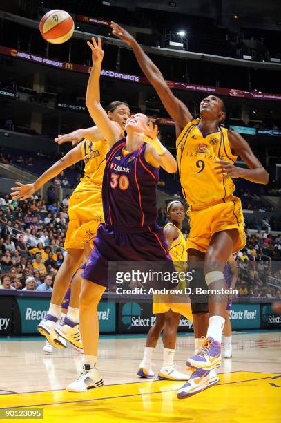 Lisa Leslie and Lindsay Wisdom-Hylton of the Los Angeles Sparks blocks a shot against Nicole Ohlde of the Phoenix Mercury on August 27, 2009 at...