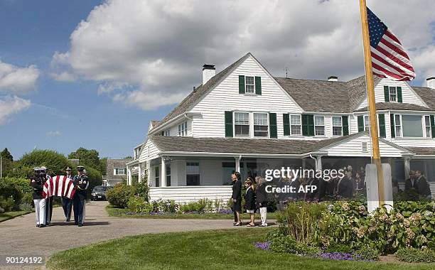 The family of US Sen. Edward Kennedy, watch as his casket is carried by an Honor Guard, to a hearse at the Kennedy compound in Hyannis Port,...