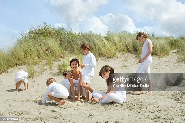 children practising yoga at the beach - helm riet stockfoto's en -beelden