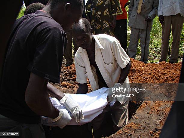 Villagers from Amoyo Koma bury on July 9, 2009 the remains of a woman who was a victim of attacks of rebels from the Lord's Resistance Army against...