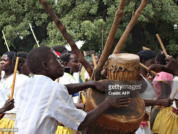 Villagers from Amoyo Koma dance during a burial ceremony on July 9, 2009 for the remains of a woman who was a victim of attacks of rebels from the...