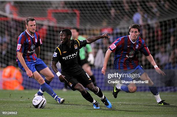 Shaun Wright-Phillips of Manchester City is closely watched by Paddy McCarthy and Clint Hill of Crystal Palace during the Carling Cup second round...