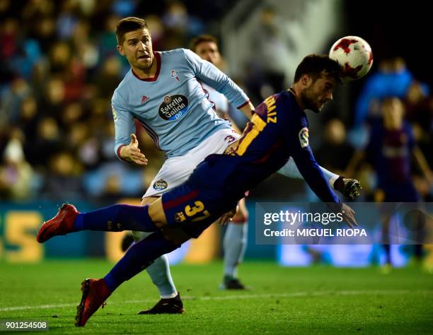 Barcelona's Spanish forward Jose Arnaiz heads the ball beside Celta Vigo's defender Andreu Fontas during the Spanish Copa del Rey football match RC...