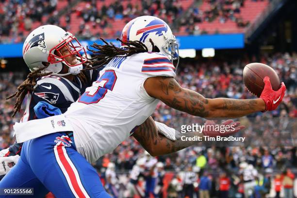 Kelvin Benjamin of the Buffalo Bills catches a touchdown pass as he is defended by Stephon Gilmore of the New England Patriots during the second...