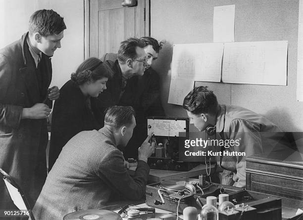 Radio enthusiasts share their interests at the Pioneer Health Centre in Peckham, 1949. The centre is a place for leisure activities for local people...