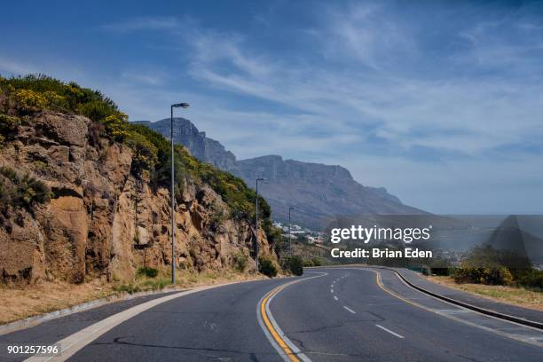 a winding coastal road in cape town, south africa - camps bay stock-fotos und bilder