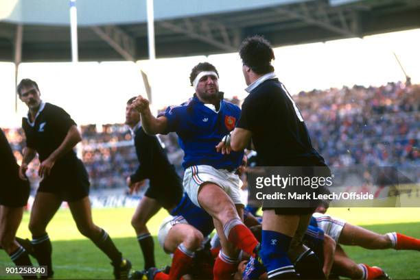 November 1986 Nantes : Rugby Union International match - France v New Zealand : French forward Pascal Ondarts takes a kick at Steve McDowell of NZ .
