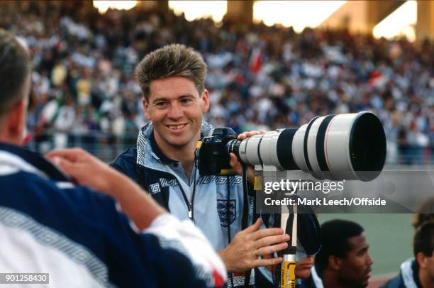 Fifa World Cup 3rd place match : Italy v England - Chris Waddle holds the camera and telephoto lens of a photographer .