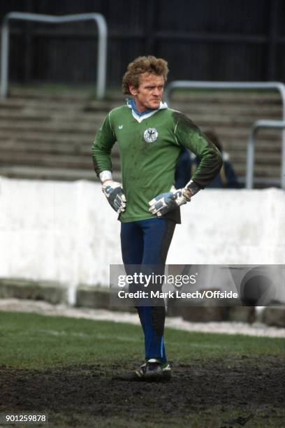 West Germany football squad training : Goalkeeper Sepp Maier stands in the muddy goalmouth .