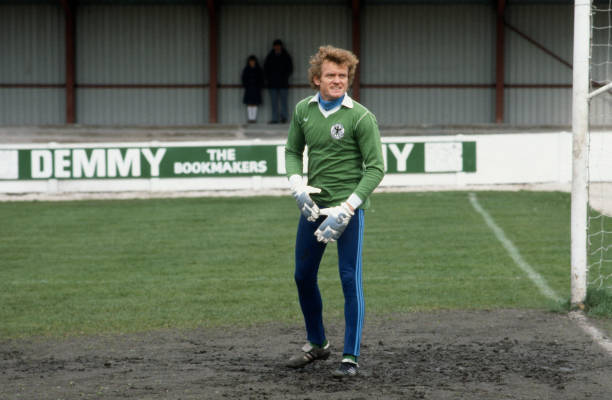 West Germany football squad training : Goalkeeper Sepp Maier stands in the muddy goalmouth .