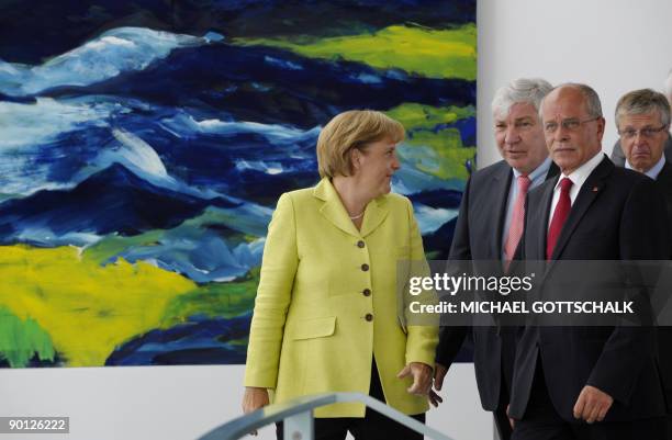 German Chancellor Angela Merkel, the head of the federation of German trade unions Michael Sommer, the head of the German industrial trade union IG...