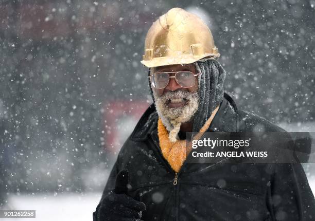 Man walks through the snow on January 4, 2018 in Brooklyn, New York. A giant winter "bomb cyclone" walloped the US East Coast on Thursday with...