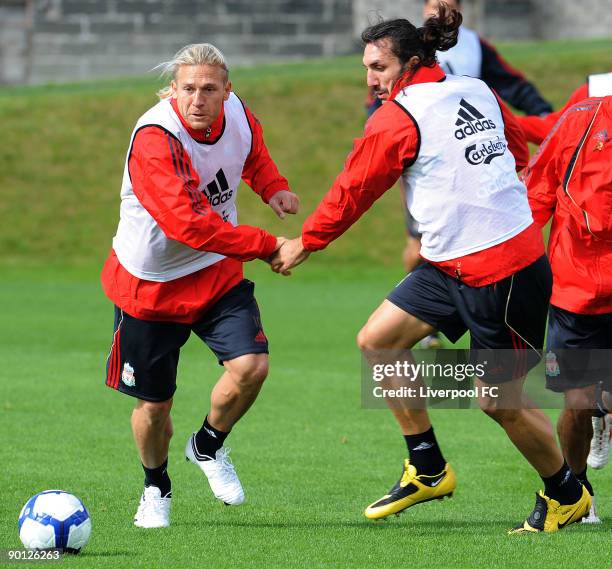 Andriy Voronin in action with new signing Sotirios Kyrgiakos of Liverpool during a training session at Melwood on August 28, 2009 in Liverpool,...