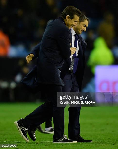 Celta Vigo's coach Juan Carlos Unzue cheers Barcelona's Spanish coach Ernesto Valverde at the end of the Spanish Copa del Rey football match RC Celta...